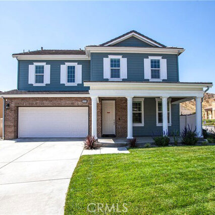 Blue and white and brick two story house.