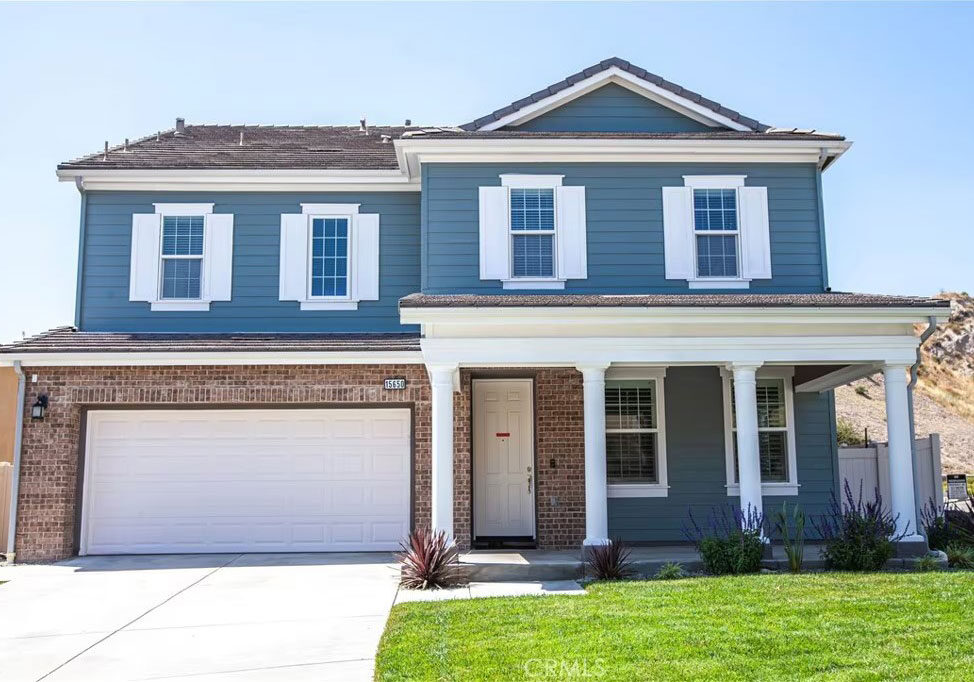 Blue and white and brick two story house.